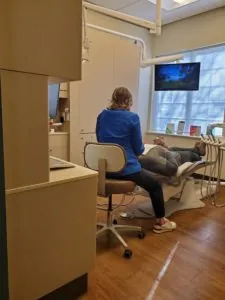 dentist working with anxious patient using sedation dentistry