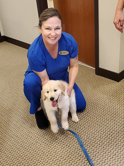 photo of staff member and puppy at Robert M. Kelso DDS