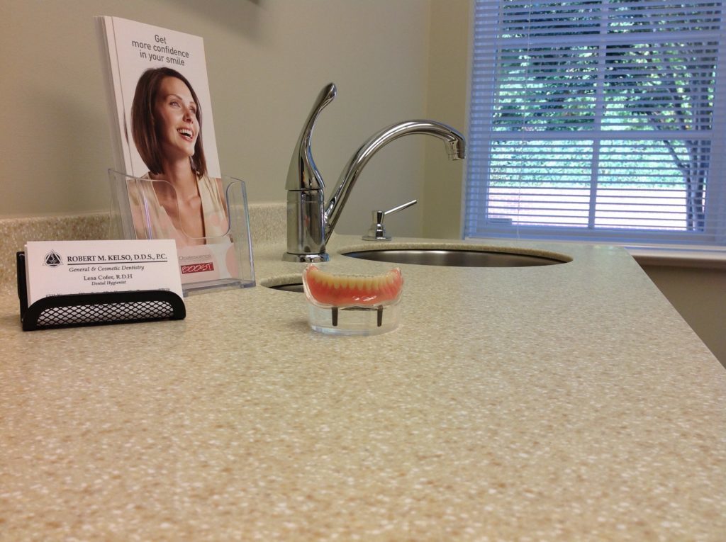 A pair of dentures sitting on a counter are part of the restorative dentistry menu of services at Robert M Kelso DDS in Knoxville TN.